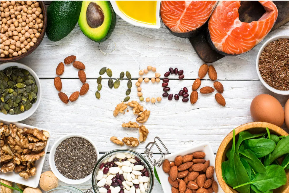 A colorful array of omega-3 rich foods, including salmon, walnuts, and chia seeds, arranged on a wooden table.