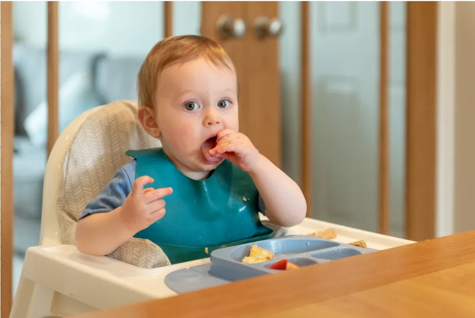 A 10-month-old baby exploring toys, showcasing physical and cognitive developmental milestones.