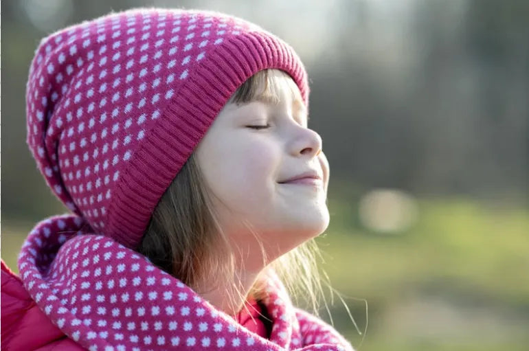 A child practicing breathing exercises to manage anxiety, surrounded by calming visuals and supportive materials.