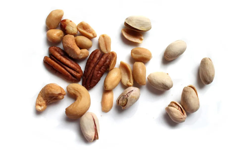 A variety of nuts arranged on a wooden table, symbolizing brain food for mental clarity and focus.